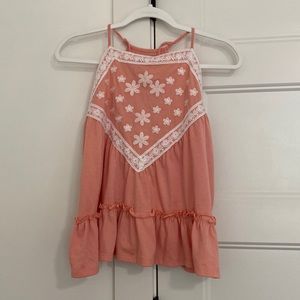 Women’s pink and white tank top with adjustable straps and flows at the bottom